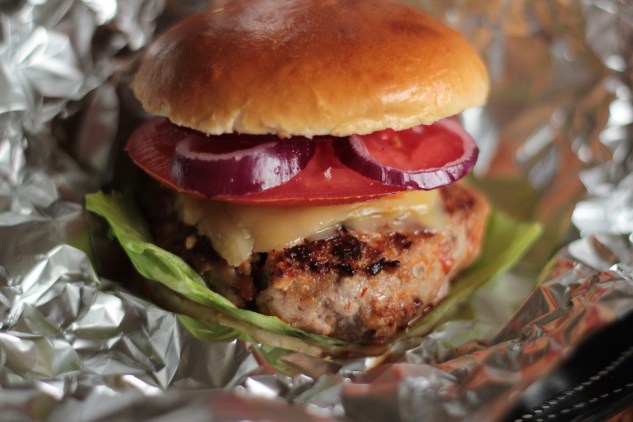 Wrapping the burgers in tin foil, ready for the oven