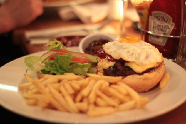 The burger was served open-faced with the fried egg on top.