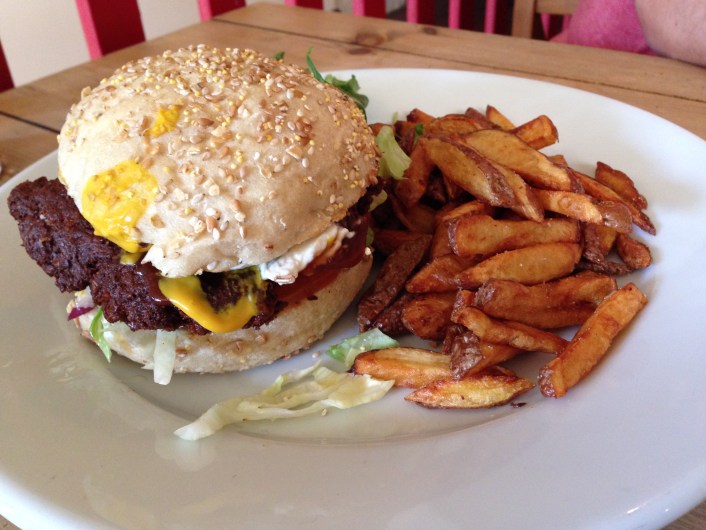 Topped with barbecue sauce, American musterd, pickle, red onion, lettuce & tomato.