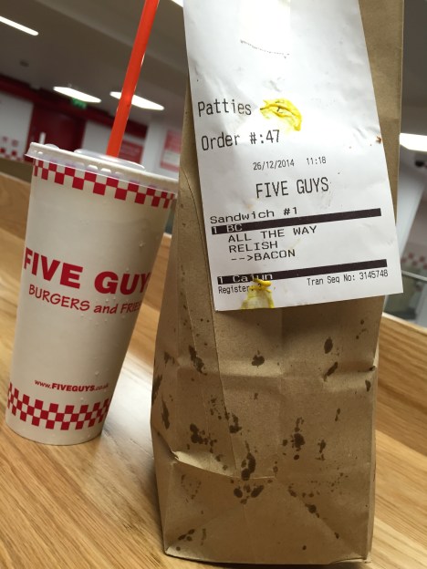 Your collect your order in a brown bag, mustard stains and all.